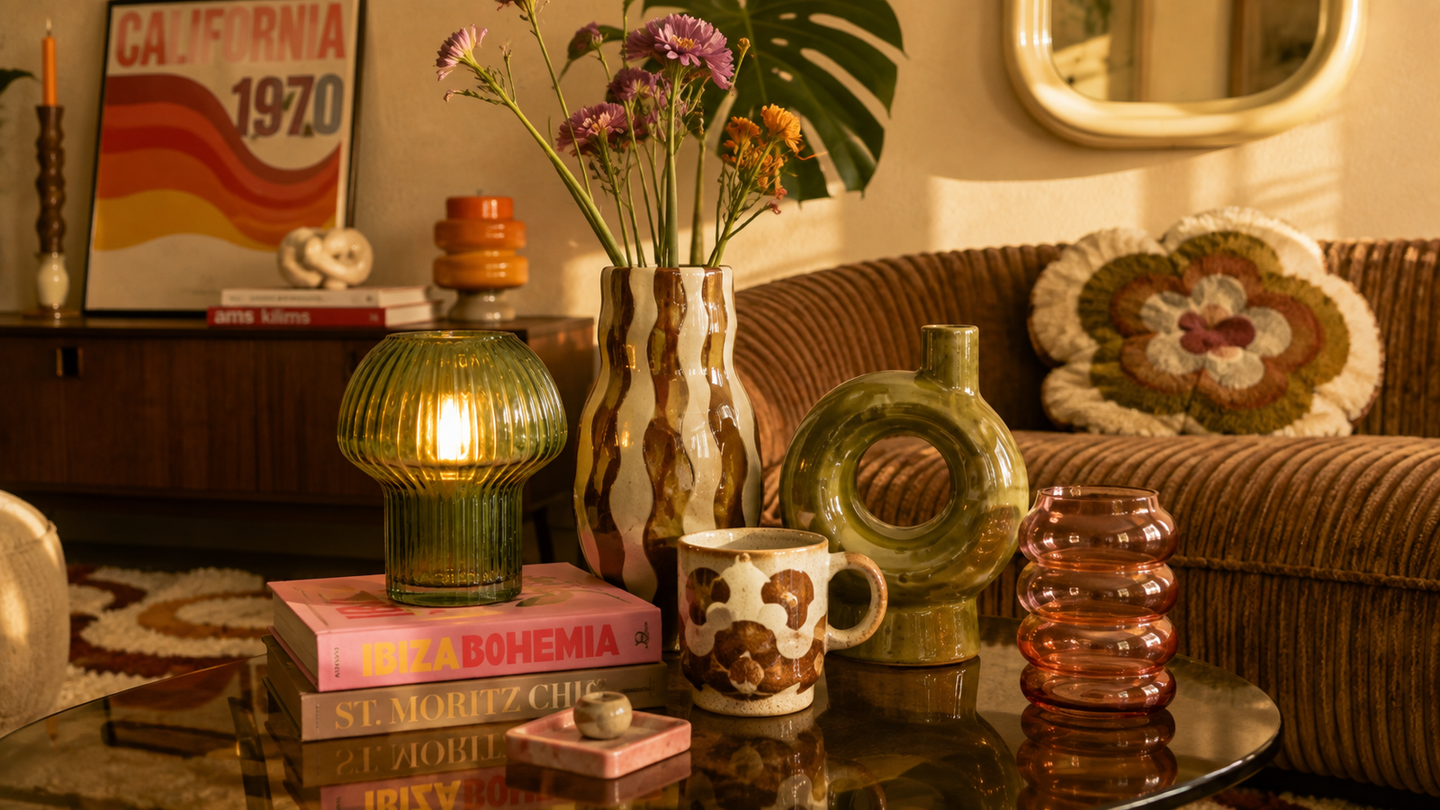 Betaalbare woonaccessoires in kleurrijke HKliving-stijl met glazen lamp, vaas en keramieken koffiekopjes.